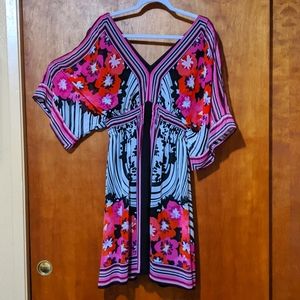 Lightly used, adorable and breezy summer dress. Sleeves have arm-opening.